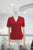 Blusa brillosa roja